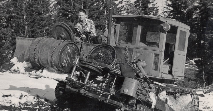 Man driving an old tractor on the snow