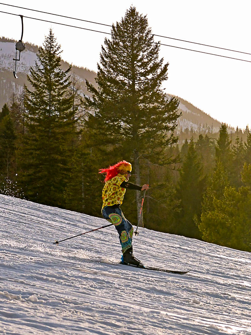Man skiing in a red wig and Hawaiian shirt